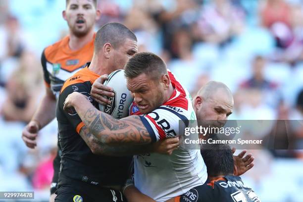 Jared Waerea-Hargreaves of the Roosters is tackled during the round one NRL match between the Wests Tigers and the Sydney Roosters at ANZ Stadium on...