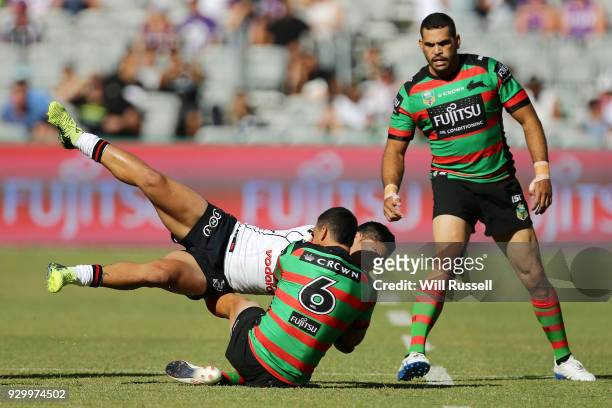 Issac Luke of the Warriors is tackled by Cody Walker of the Rabbitohs during the round one NRL match between the South Sydney Rabbitohs and the New...