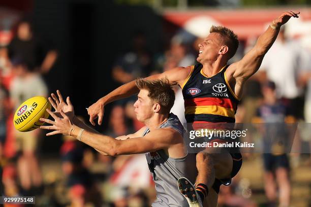 Dougal Howard of the Power and David Mackay of the Crows compete for the ball during the JLT Community Series AFL match between Port Adelaide Power...