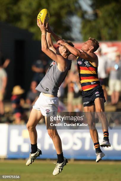 Dougal Howard of the Power and David Mackay of the Crows compete for the ball during the JLT Community Series AFL match between Port Adelaide Power...