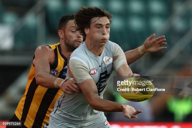 Caleb Marchbank of the Blues handballs during the JLT Community Series AFL match between the Hawthorn Hawks and the Carlton Blues at the University...