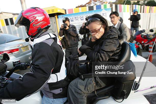 Police give a ride to a student who is about to miss the College Scholastic Ability Test at a school on November 12, 2009 in Seoul, South Korea. More...