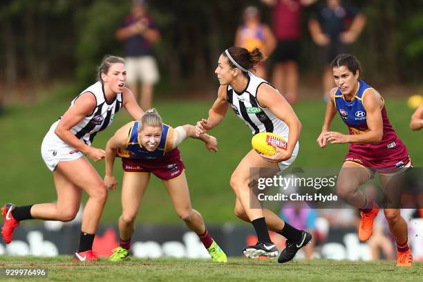 Ash Brazill of the Magpies runs the ball during the round six AFLW match between the Brisbane Lions and the Collingwood Magpies at Moreton Bay Sports...