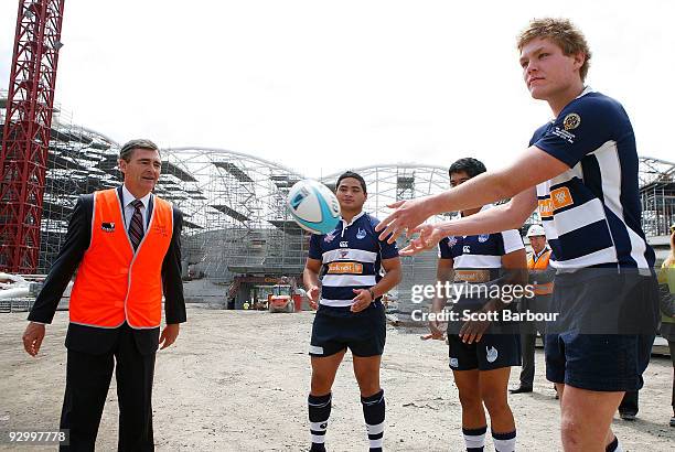 John Brumby , Premier of Victoria passes a rugby ball with Victorian based Australian schoolboy rugby players during a press conference to announce...