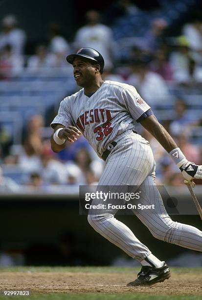 Outfielder Dave Winfield of the Minnesota Twins swings and watches the flight of his ball against the New York Yankees during a circa 1993 Major...