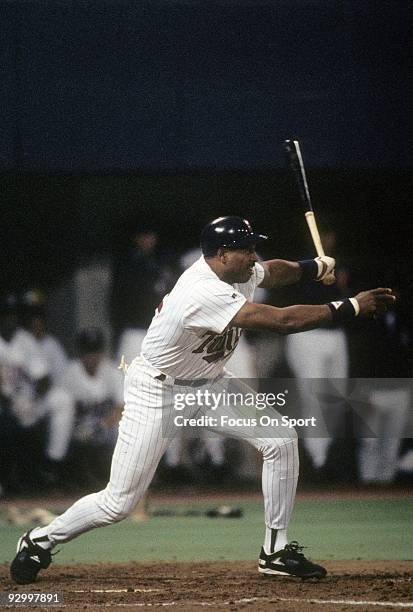 Outfielder Dave Winfield of the Minnesota Twins swings and watches the flight of his ball as he get his 3000th career hit off of Dennis Eckersly of...