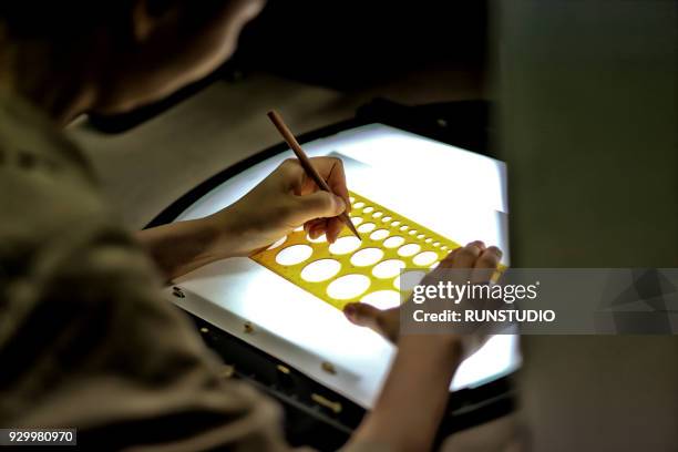 woman drawing template on light table - light box table stock pictures, royalty-free photos & images