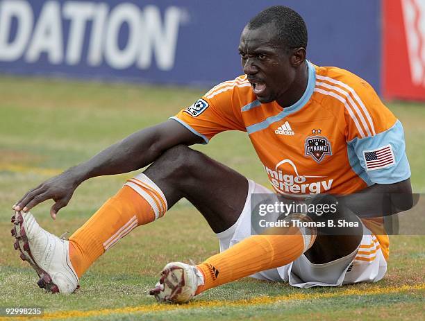 Dominic Oduro of the Houston Dynamo stretches a cramp while playing against the Seattle Sounders on November 8, 2009 at Robertson Stadium in Houston,...