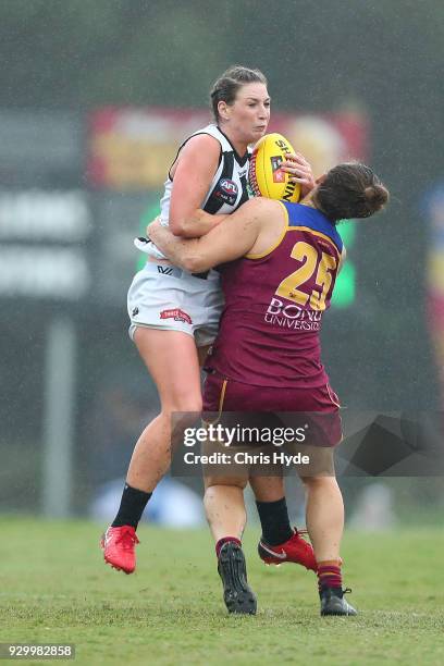 Amelia Bardon of the Magpies is tackled during the round six AFLW match between the Brisbane Lions and the Collingwood Magpies at Moreton Bay Sports...