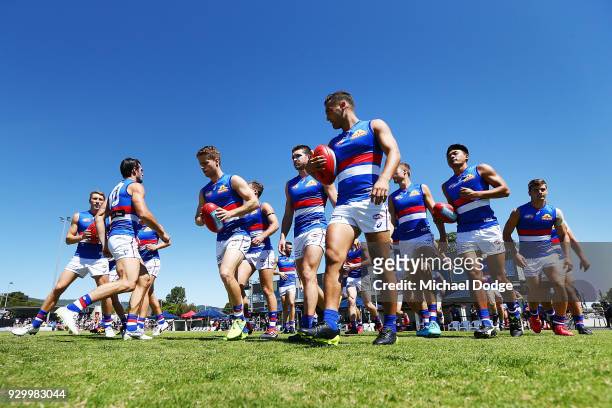 Bulldogs players enter the field of play during the JLT Community Series AFL match between Collingwood Magpies and the Western Bulldogs at Ted...