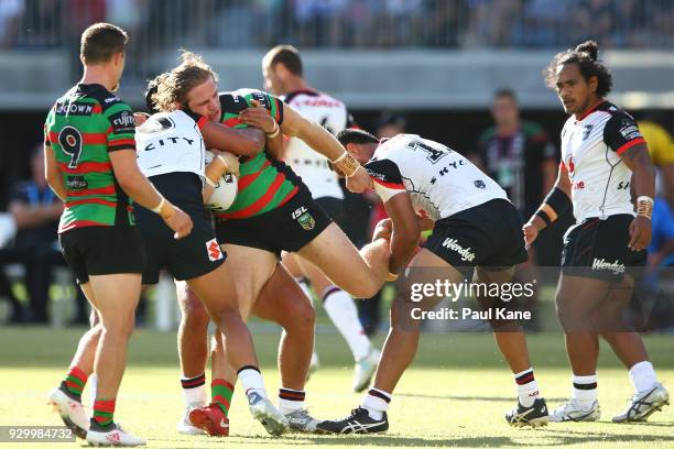 George Burgess of the Rabbitohs gets tacked during the round one NRL match between the South Sydney Rabbitohs and the New Zealand Warriors at Optus...