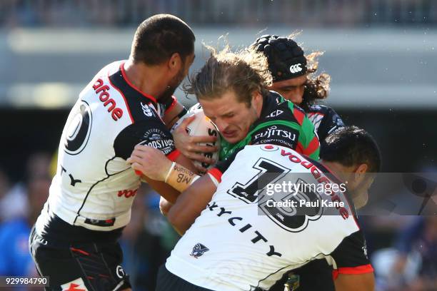 George Burgess of the Rabbitohs gets tacked during the round one NRL match between the South Sydney Rabbitohs and the New Zealand Warriors at Optus...