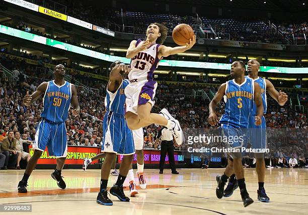 Steve Nash of the Phoenix Suns lays up a shot past Chris Paul of the New Orleans Hornets during the NBA game at US Airways Center on November 11,...