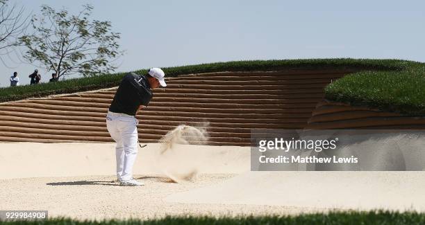 Emiliano Grillo of Argentina plays out of a bunker on the 4th hole during day three of the Hero Indian Open at Dlf Golf and Country Club on March 10,...