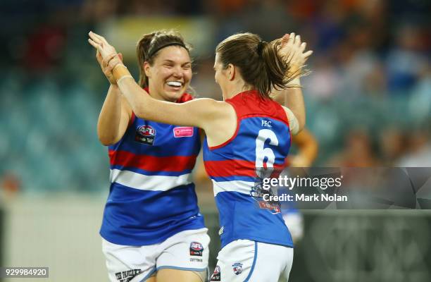 Kirsten McLeod of the Bulldogs celebrates kicking a goal with a team mate during the round six AFLW match between the Greater Western Sydney Giants...