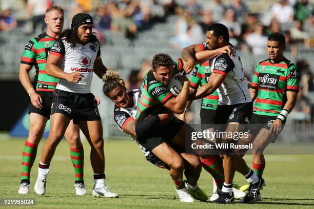 Sam Burgess of the Rabbitohs is tackled by James Gavet of the Warriors during the round one NRL match between the South Sydney Rabbitohs and the New...