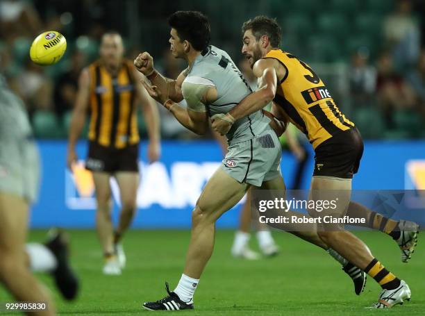 Matthew Kennedy of the Blues is challenged by Ricky Henderson of the Hawks during the JLT Community Series AFL match between the Hawthorn Hawks and...