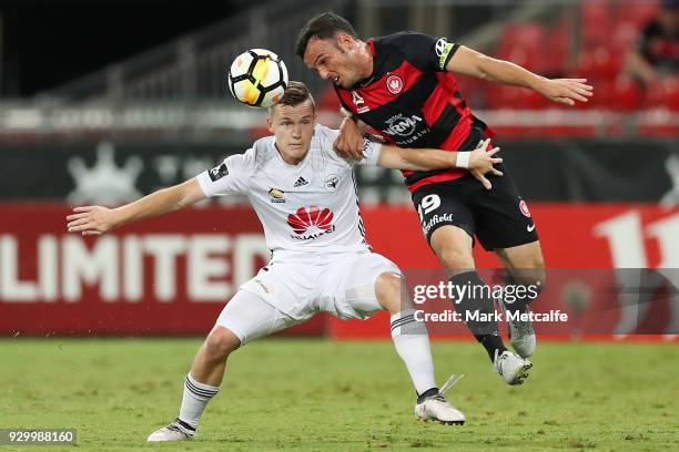 Mark Bridge of the Wanderers wins a header ahead of Scott Galloway of The Phoenix during the round 22 A-League match between the Western Sydney...