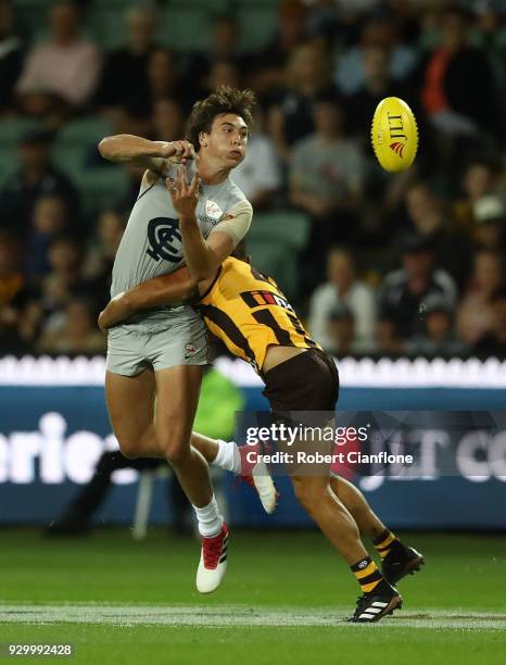 Caleb Marchbank of the Blues handballs during the JLT Community Series AFL match between the Hawthorn Hawks and the Carlton Blues at the University...