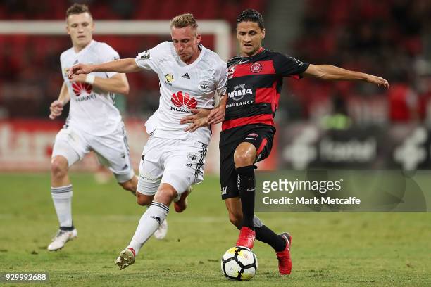 Marcelo Carrusca of the Wanderers and Goran Paracki of The Phoenix compete for the ball during the round 22 A-League match between the Western Sydney...