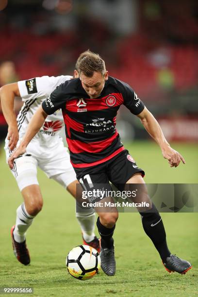 Brendon Santalab of the Wanderers is challenged by Andrew Durante of the Phoenix during the round 22 A-League match between the Western Sydney...