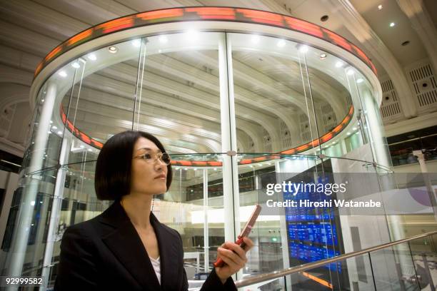 business woman text messaging on cellular phone - tokyo stock exchange stock pictures, royalty-free photos & images