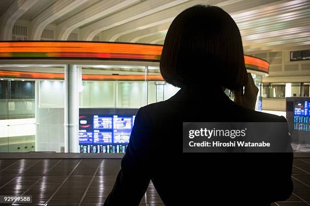 business woman talking with cellular phone - tokyo stock exchange stock pictures, royalty-free photos & images