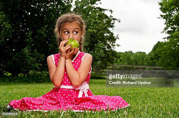 young girl sitting on grass - freshness guard stock pictures, royalty-free photos & images