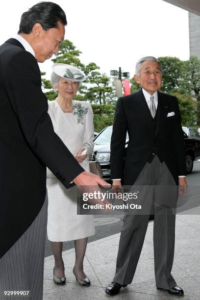 Japanese Emperor Akihito and Empress Michiko are escorted by Japanese Prime Minister Yukio Hatoyama upon their arrival at the memorial ceremony in...