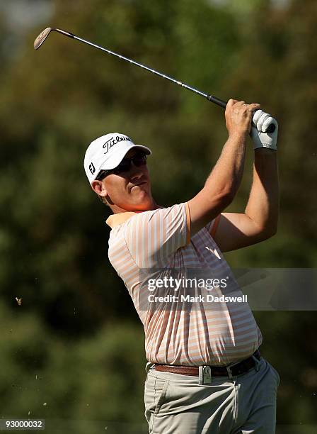 Ryan Haller of Australia plays an approach shot on the 14th hole during round one of the 2009 Australian Masters at Kingston Heath Golf Club on...