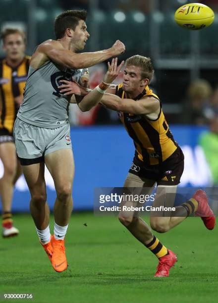 Marc Murphy of the Blues handballs during the JLT Community Series AFL match between the Hawthorn Hawks and the Carlton Blues at the University of...