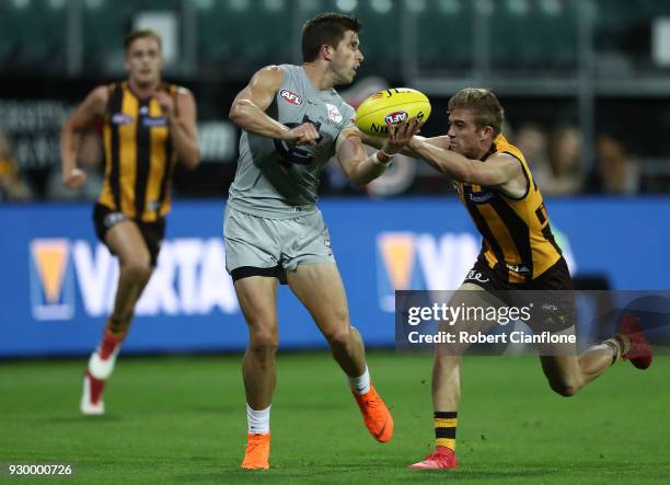 Marc Murphy of the Blues handballs during the JLT Community Series AFL match between the Hawthorn Hawks and the Carlton Blues at the University of...