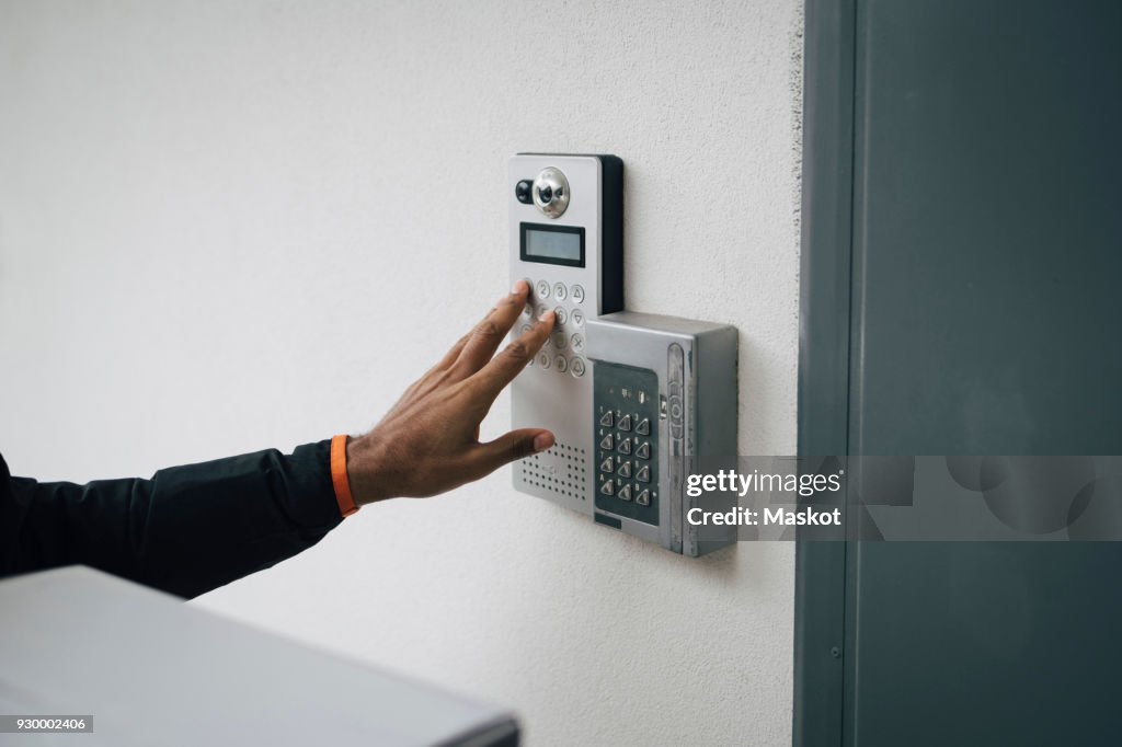Intercom Ringing Phone Cropped Image Of Delivery Man Ringing Intercom On Wall High-Res Stock ...
