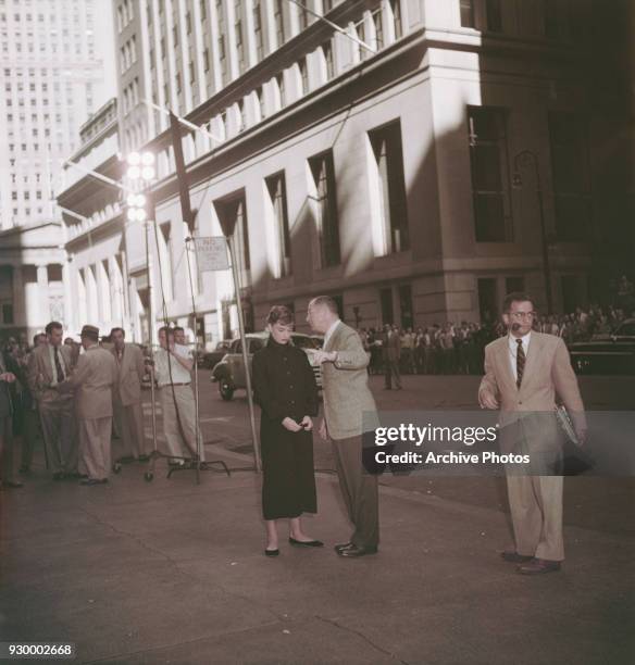 Director Billy Wilder instructs Belgian-born actress Audrey Hepburn on the set of the film, 'Sabrina', at 30 Broad Street, Manhattan, New York City,...