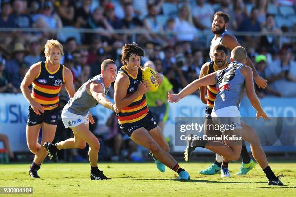 Darcy Fogarty of the Crows runs with the ball during the JLT Community Series AFL match between Port Adelaide Power and the Adelaide Crows at...