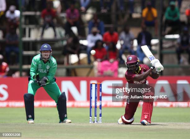 Nial O'Brien of Ireland looks on as Rovman Powell of The West Indies scores runs during The ICC Cricket World Cup Qualifier between The West Indies...