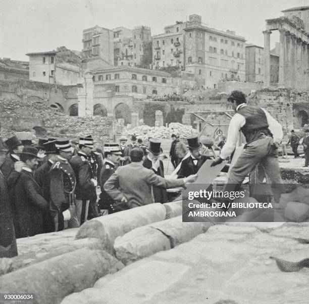 The architect Boni, director of excavations at the Roman Forum, showing Vittorio Emanuele III and the French President Emile Loubet the plan of the...