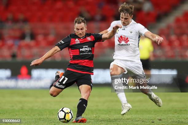 Brendon Santalab of the Wanderers is challenged by Dylan Fox of the Phoenix during the round 22 A-League match between the Western Sydney Wanderers...