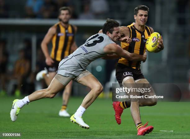 Ryan Burton of the Hawks is challenged by Jed Lamb of the Blues during the JLT Community Series AFL match between the Hawthorn Hawks and the Carlton...