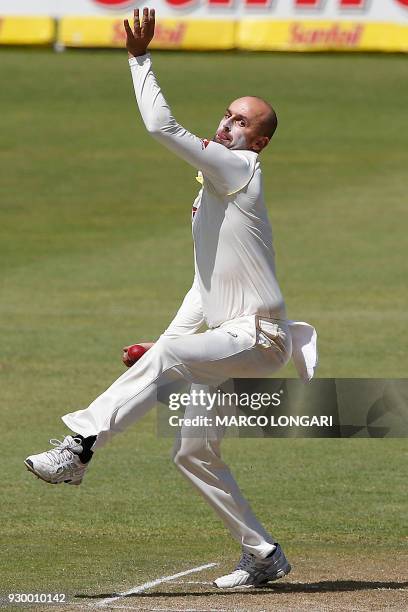 Australia's bowler Nathan Lyon delivers the ball during day two of the second Sunfoil cricket Test match between South Africa and Australia at St...