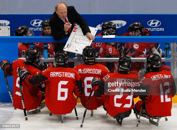 Coach of Canada give instructions for his teammates in the Ice Hockey Preliminary Round - Group A game between Canada and Sweden during day one of...