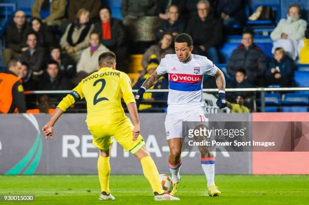 Memphis Depay of Olympique Lyon is tackled by Mario Gaspar Perez Martínez of Villarreal CF during the UEFA Europa League 2017-18 Round of 32 match...