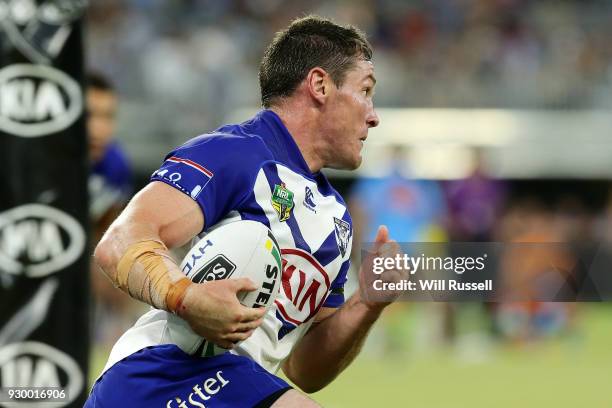 Josh Jackson of the Bulldogs runs the ball during the round one NRL match between the Canterbury Bulldogs and the Melbourne Storm at Perth Stadium on...