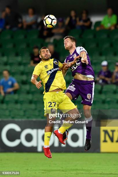 Peter Skapetis of the Mariners and Alex Grant of the Glory contest a header during the round 22 A-League match between the Perth Glory and the...