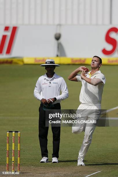 Australian bowler Pat Cummins delivers a ball during the second days play of the second cricket Test match between South Africa and Australia at St...