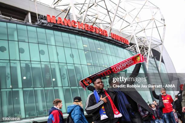 Fans of Manchester Untied have a photo outside prior to the UEFA Champions League Round of 16 Second Leg match between Manchester City and FC Basel...