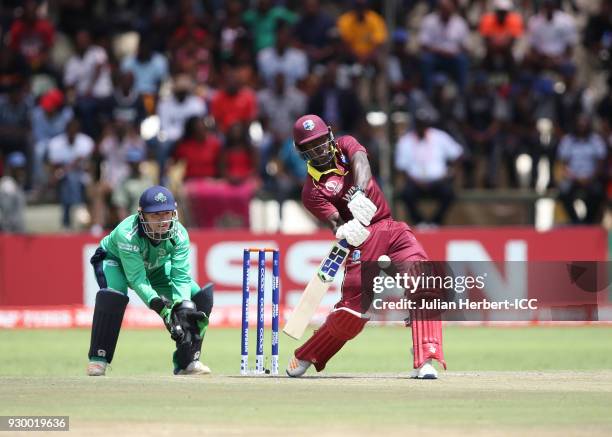 Nial O'Brien of Ireland looks on as Rovman Powell of The West Indies hits out during The ICC Cricket World Cup Qualifier between The West Indies and...