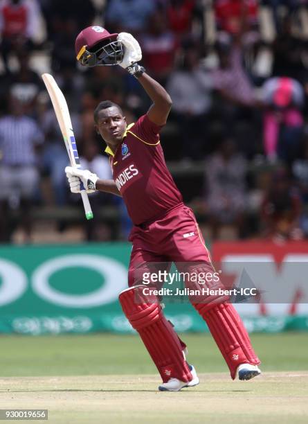 Rovman Powell of The West Indies celebrates his century during The ICC Cricket World Cup Qualifier between The West Indies and Ireland at The Harare...