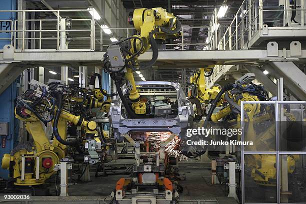 Arm robots assemble parts at Nissan's Tochigi Plant as Nissan announce the opening of the latest FUGA motor car production line on November 12, 2009...