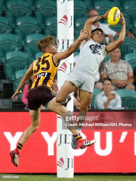 Jarrod Pickett of the Blues marks the ball over Harry Morrison of the Hawks during the AFL 2018 JLT Community Series match between the Hawthorn Haws...